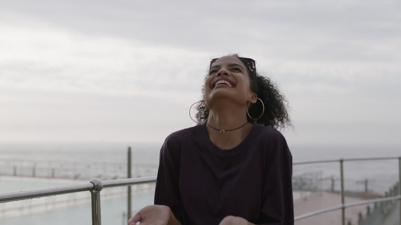 retrato de una hermosa mujer hispana celebrando el baile bajo la lluvia