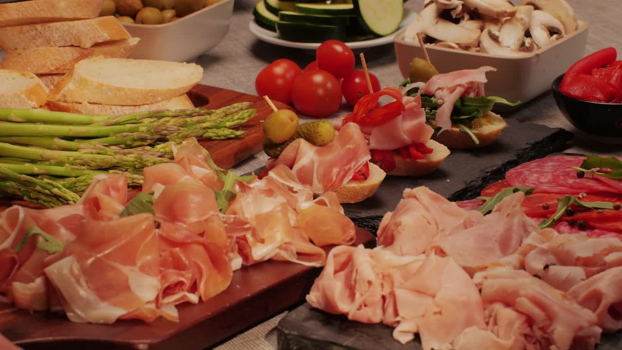 Italian or Spanish restaurant with traditional tapas food, Spanish cuisine, delicious tapas and cheese plate, bruschetta with cheese, olives dry tomatoes and tasty sandwich bar appetizer, buffet
