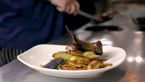 plating lambchops with stewed green beans and potatoes - organic grass-fed lambchop recipe - close up