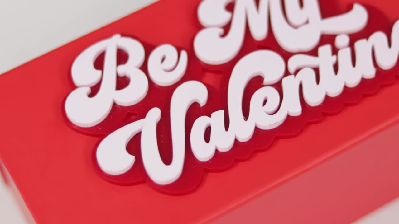 Red gift box with Be My Valentine text in cool font, white background