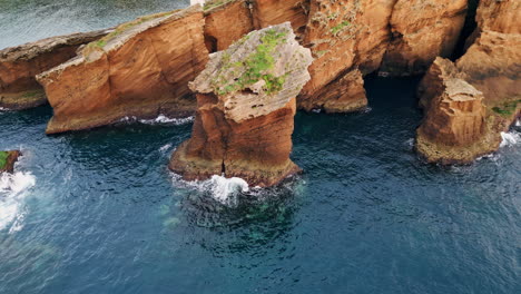 amazing cliffs coastline drone shot. breathtaking rocky formations washed by sea