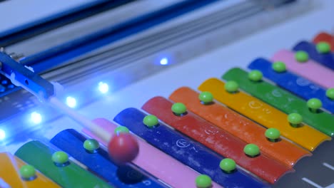 robot playing on colorful xylophone