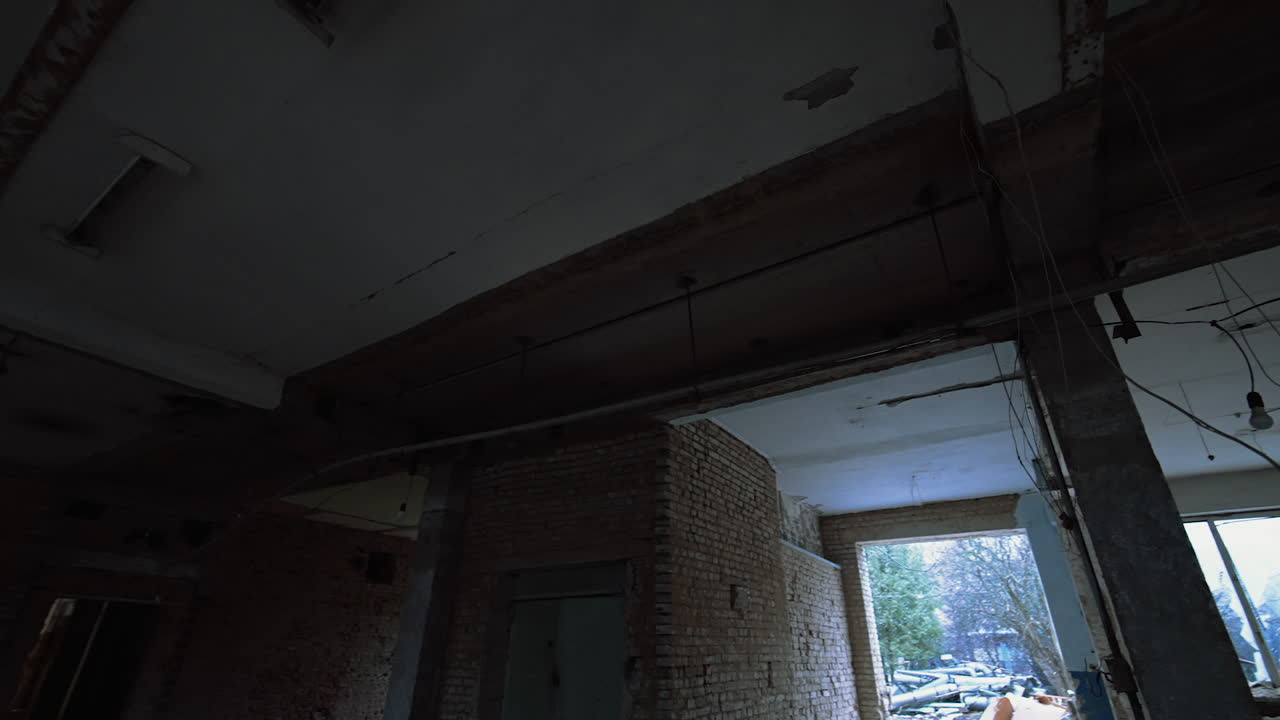 Ceiling of a big premise in the old building. Low angle view on the ceiling with multiple wires hanging from it.
