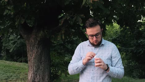 Man-in-a-shirt-with-glasses-takes-vitamins