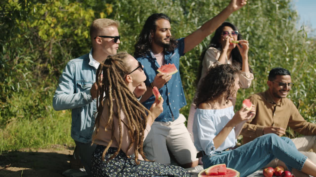 Friends Enjoying a Watermelon Picnic