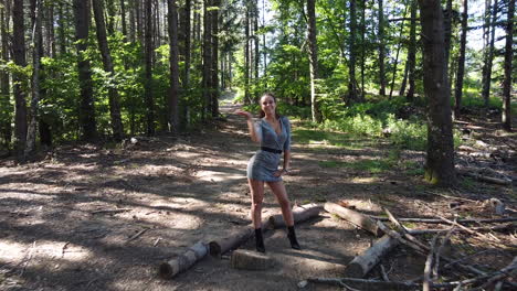 joven caucásica saludable besándose hacia la cámara dentro de un bosque mágico en un día soleado, a principios de verano