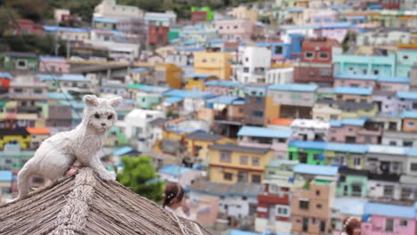 colorful town with a cat on a roof