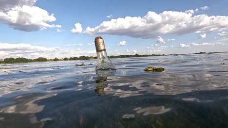 glass bottle, garbage floating in the san francisco river polluting