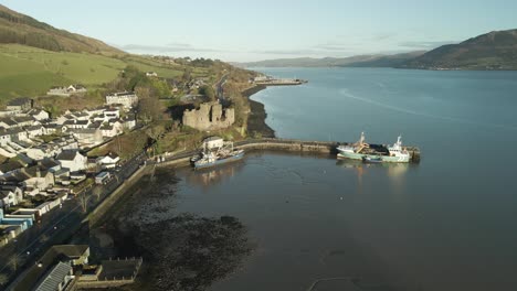 ships at carlingford harbour with carlingford castle in county louth, ireland