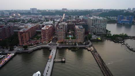 Aerial-tracking-shot-of-the-riverfront-of-Hoboken,-gloomy-evening-in-New-Jersey