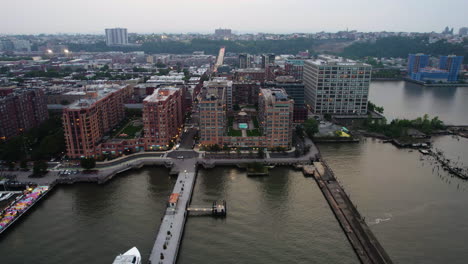 aerial tracking shot of the riverfront of hoboken, gloomy evening in new jersey