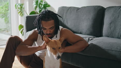 tender owner petting dog at home closeup. guy enjoying time with domestic animal