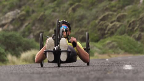 disabled man riding a recumbent bicycle