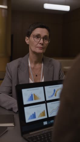 businesswoman reviewing graphs in a meeting