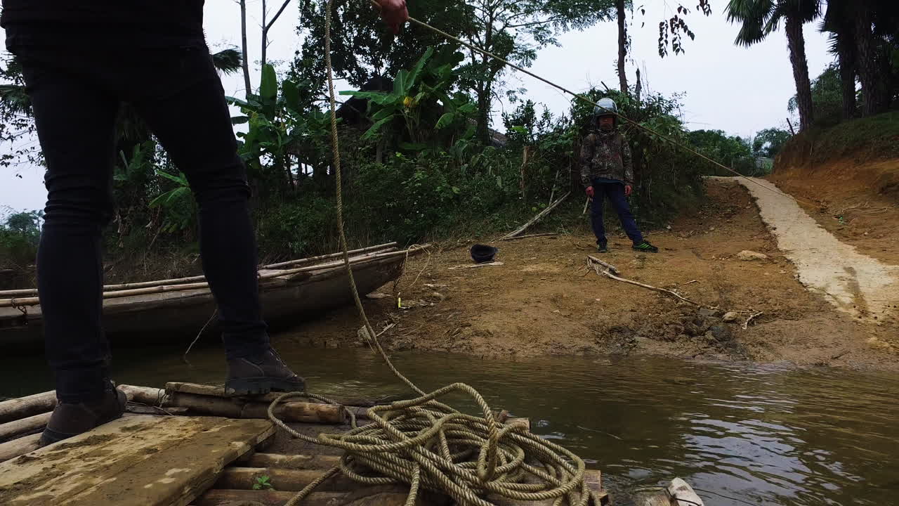 Manual hand pull of a wooden raft at Thac Ba Lake,Vu Linh, pov shot