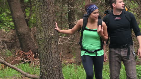 fit couple exploring a wooded area