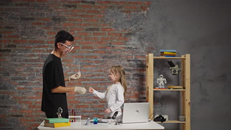 chemist and girl play choosing next experiment in lab