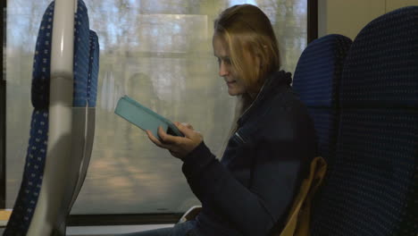 woman with tablet pc on train