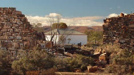 rugged beauty of the australian outback captured through historic stone ruins. a distant building in the flinders ranges, south australia.
