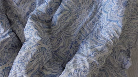 wrinkled blue and white patterned bedding