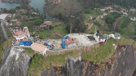 Aerial-over-big-rock-with-people-on-at-El-Peñol-in-Colombia