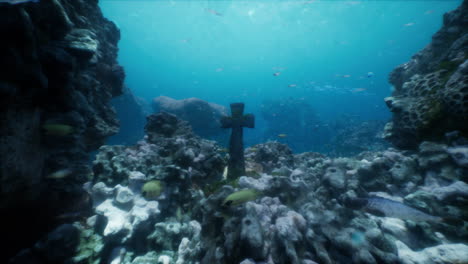 underwater cross among coral reefs