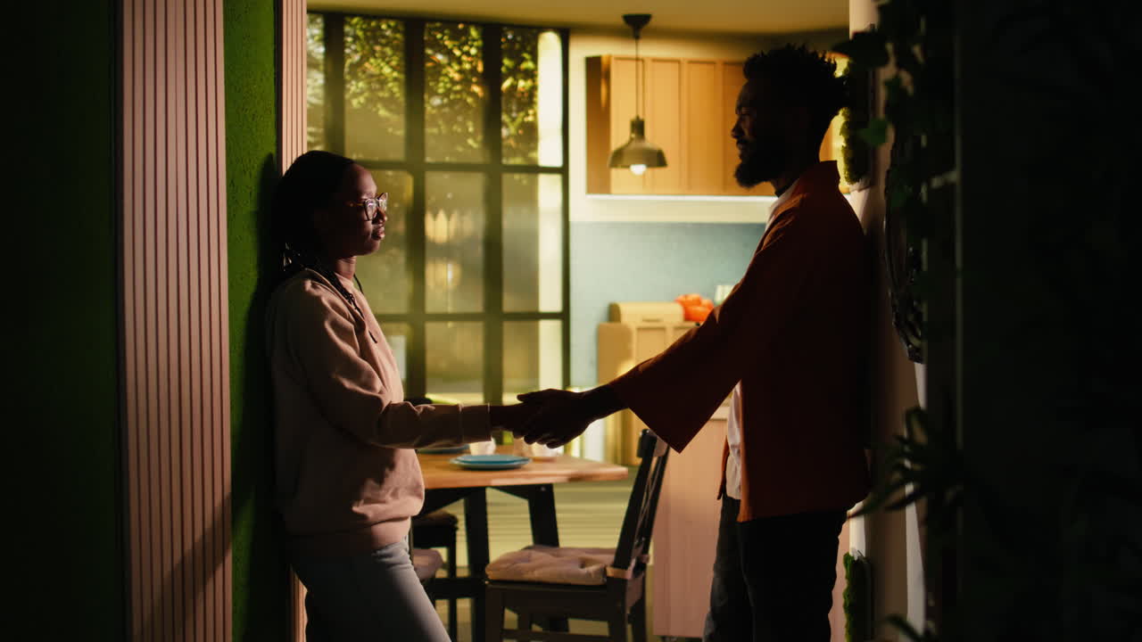 African american couple holding hands and making up after fight