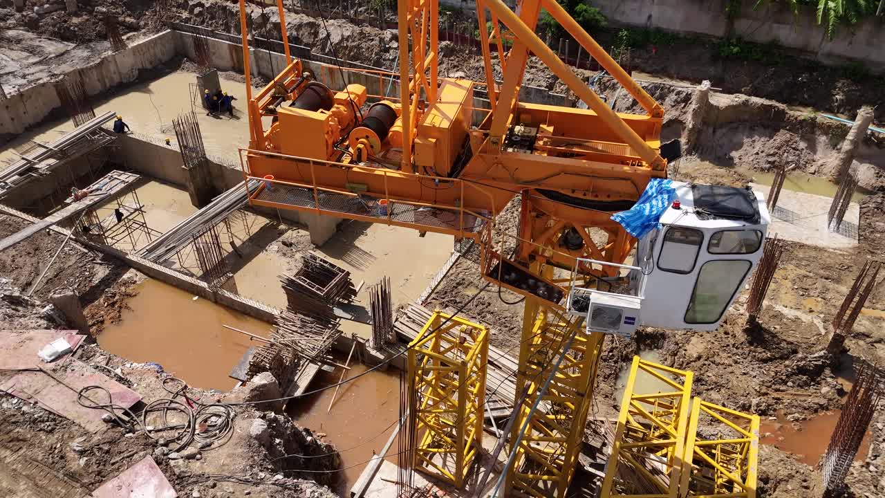 Aerial View of Construction Site with Crane and Workers