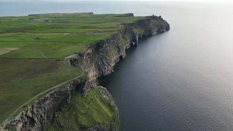 Drone-shot-flying-along-the-Cliffs-of-Moher-at-sunset