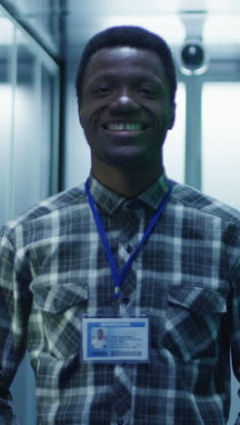 smiling it professional with id badge in data center