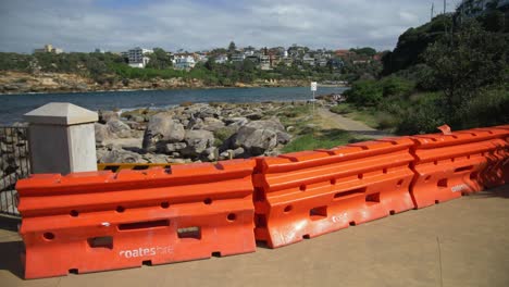 orange barriers block access to the beach in gordons bay - eastern suburbs - coronavirus pandemic in sydney, nsw, australia