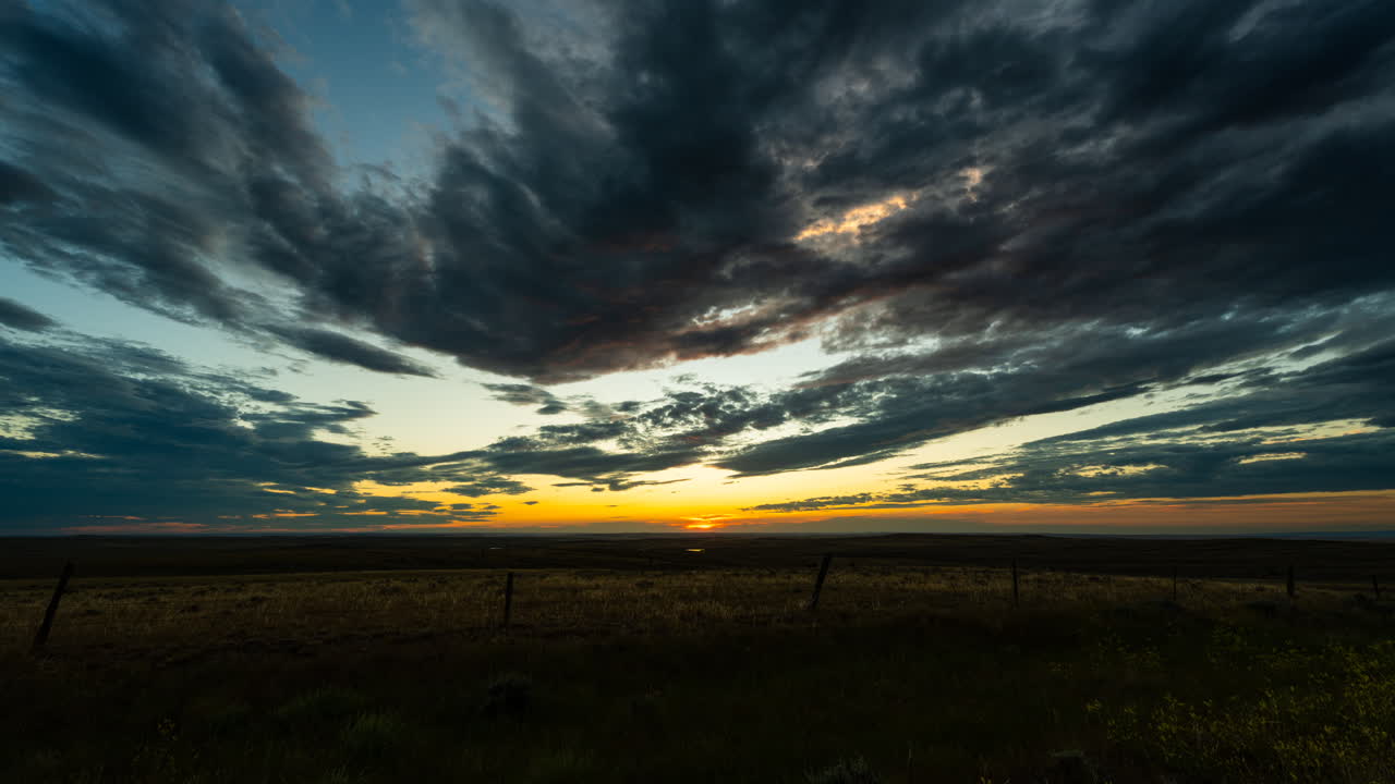 Drifting clouds and colorful sunset in a calming time lapse