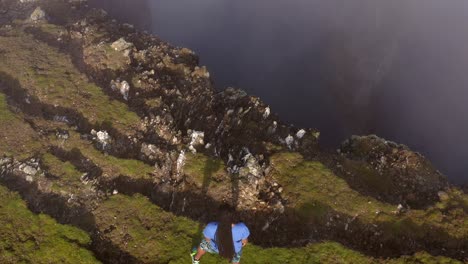 man standing on a cliff