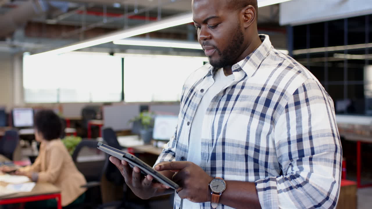 African american man using tablet in casual business setting, copy space