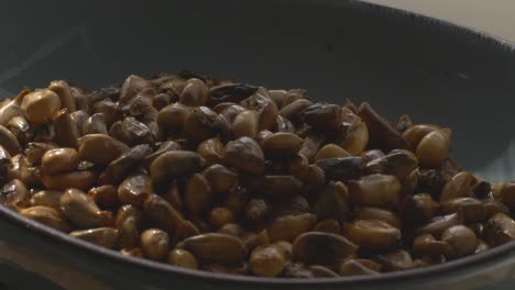 putting the toasted cancha corn on a plate