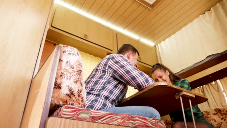 stairs view of happy young couple in a retro camper van