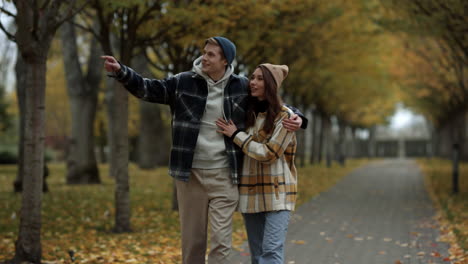 Beautiful-young-couple-in-love-walking-in-fall-park.-Smiling-handsome-guy.