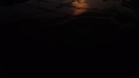 revealing tilt of stunning sunrise reflected by flood plains