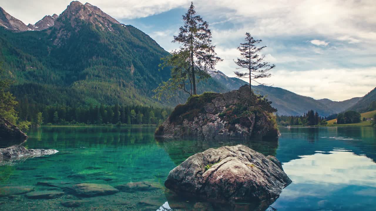 Cinemagraph of Lake Hintersee with conifer trees on rocky islands and ...