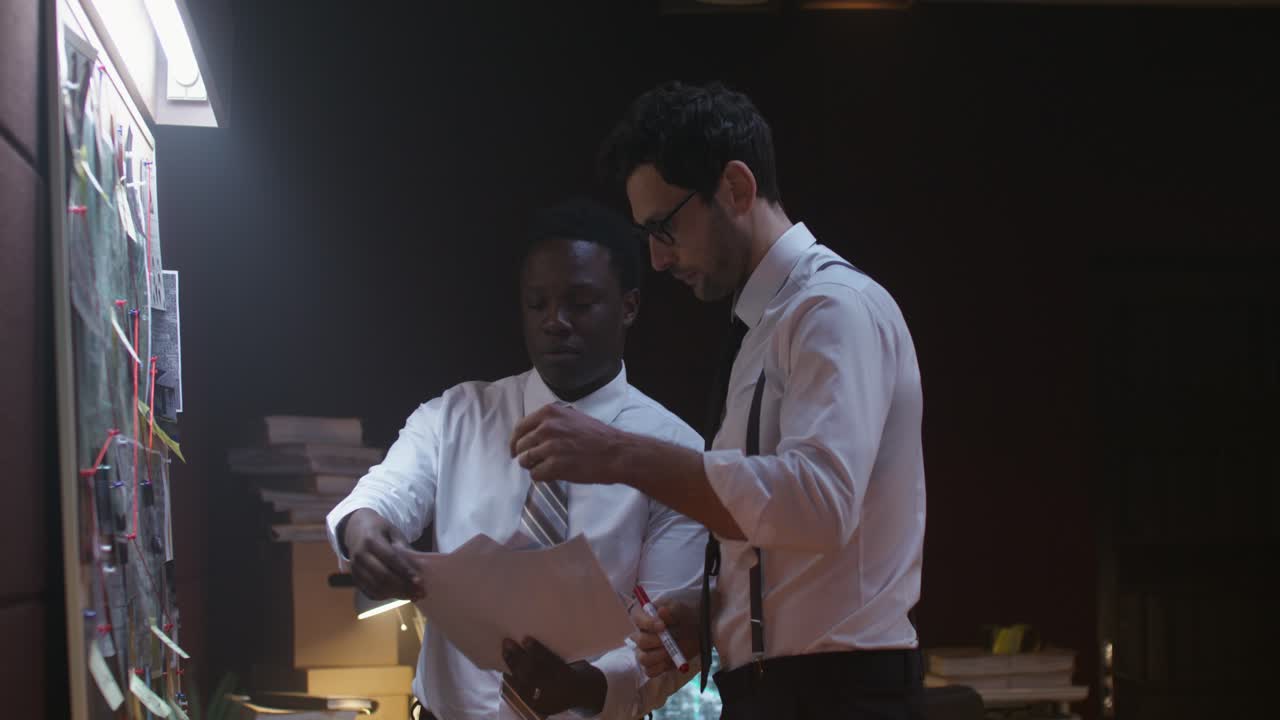 Two colleagues reviewing documents in an office
