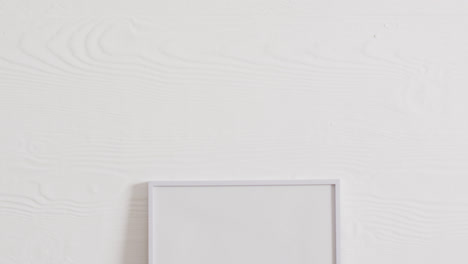 white frame with copy space on white background and white wall