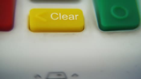 a macro close up shot of a pin pad numbers and letters on colorful buttons, smooth pull down movement, full hd video, super slow motion, blurry depth of field