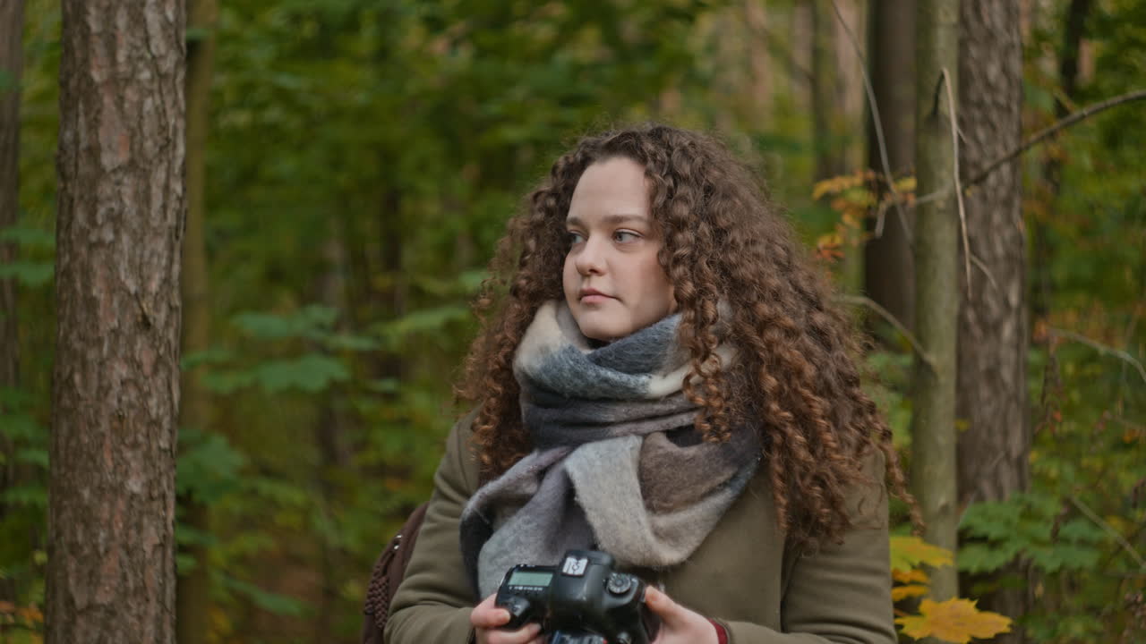 Woman taking photos in the forest