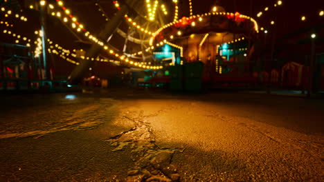 nighttime amusement park with lit attractions and silent pathways