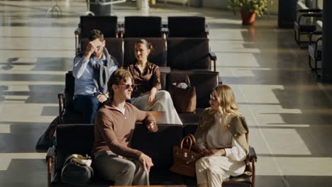 people waiting in airport lounge