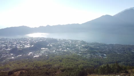 aerial view of a calm lake and village in the mountains