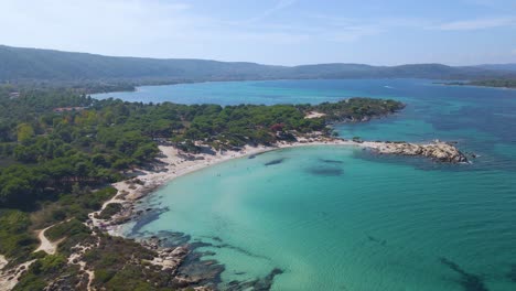 Steady-landscape-clip-over-an-exotic-beach-in-Vourvourou,-Haklidikin-in-northern-Greece-on-a-clear-summer-day