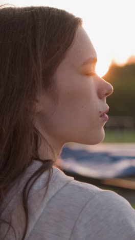 mujer deprimida se encuentra contra el atardecer. mujer joven trata de hacer frente al estado depresivo pasando tiempo en el aire fresco cerca de la noche. sentimientos de desesperanza