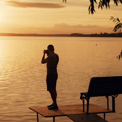 photographer taking picture of sunset at local beach which is tourists point. beautiful summer sunset.