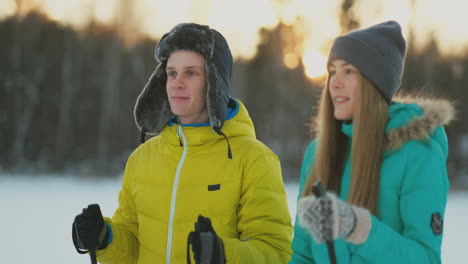 loving man and woman skiing in the winter forest doing outdoor activities leading a healthy lifestyle. slow motion